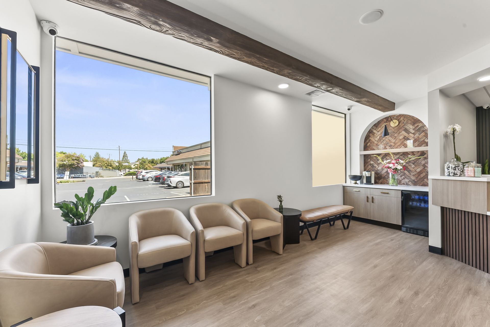 Gorgeous waiting room with tan chairs and herringbone brick arch